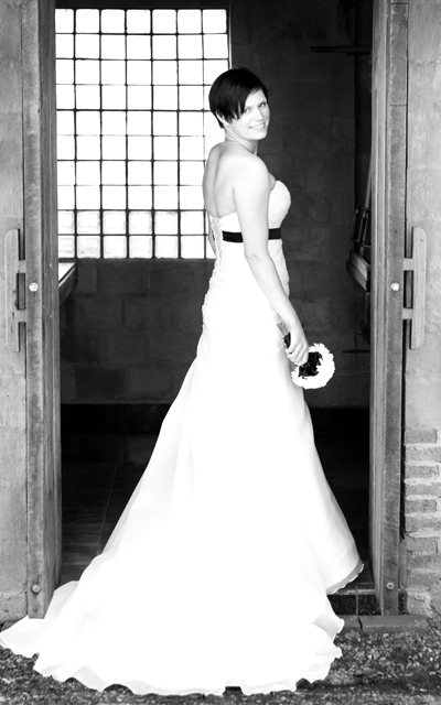 Bride Jess standing in the doorway of the family "pizza hut"